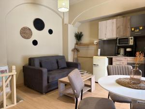 a living room with a couch and a table at Ariusa Luxury Apartments in Chios