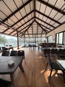 a large room with tables and chairs and windows at O'Nest Select in Peth