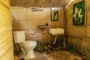 a dirty bathroom with a toilet and a sink at Kactus - Your Island Sanctuary in Koh Ta Kiev +144 photos
