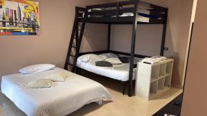 two bunk beds in a room with white sheets at Stura Home in Rome
