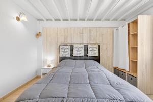 a bedroom with a large bed in a room at Location Gîte Les Iris in La Robine