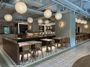a restaurant with tables and chairs and lights at Macau Hotel S in Macau