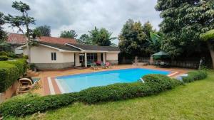 a house with a swimming pool in the yard at rossylyn lonetree two bed bedroom in Nairobi