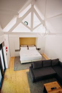 a bedroom with a white bed and a couch at Pedras Salgadas Spa & Nature Park in Pedras Salgadas +40 photos
