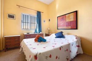 a bedroom with a bed with a teddy bear on it at Finca El Pizarro in Arico +22 photos
