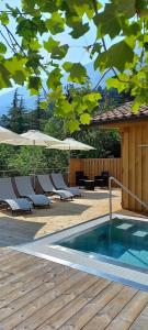 a swimming pool with chairs and umbrellas on a deck at Casa Zignon - Vezzano in Vezzano