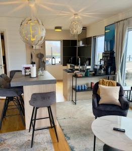 a kitchen and living room with a table and chairs at Hills Cottage Holiday Homes in Gränna