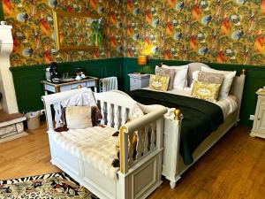 a bedroom with a bed and a wall with a mural at Nana Mac Chambre D'hôtes in Limalonges