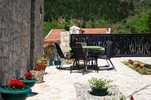 a patio with chairs and a table and flowers at Dream View Villa in Kotor +31 photos