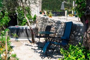 a table and a chair and a table and a table at Dream View Villa in Kotor