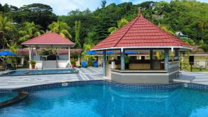a pool at a resort with a gazebo at Berjaya Praslin Resort in Anse Volbert Village