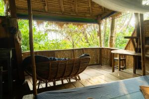 a room with a hammock on a porch at Kactus - Your Island Sanctuary in Koh Ta Kiev