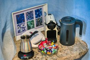 a counter with a coffee maker and a tea kettle at Mesaionas 2 in Olýmpoi +14 photos