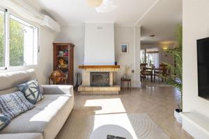 a living room with a couch and a fireplace at Beachfront Rental Home & Sea Views by Invalencia in Sagunto