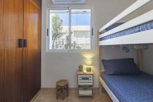 a bedroom with a bunk bed and a window at Beachfront Rental Home & Sea Views by Invalencia in Sagunto