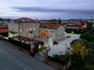a view of a house in a city at night at Villa Bido in Anguillara Veneta