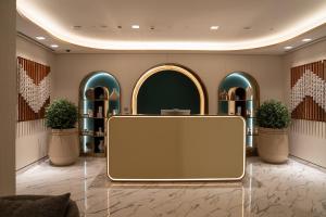 a lobby with a blank screen in the middle at Palace Dubai Creek Harbour in Dubai +81 photos