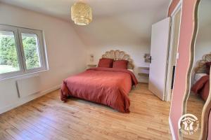 a bedroom with a bed and a large window at Ty gouldri in Perros-Guirec