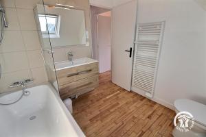 a bathroom with a tub and a sink and a toilet at Ty gouldri in Perros-Guirec +18 photos