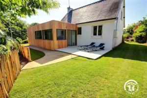 a backyard of a house with a picnic table at Ty gouldri in Perros-Guirec