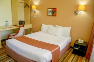 a bedroom with a bed in a hotel room at Clarion Hotel Nairobi in Nairobi