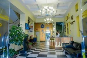 a lobby of a hospital with a man in the background at Clarion Hotel Nairobi in Nairobi