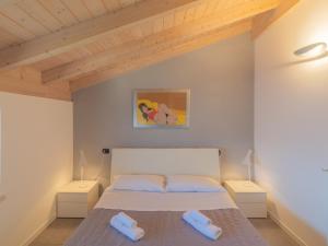 a bedroom with a bed with two pillows on it at EnjoyIseoLake - Lake View Paradise in Parzanica