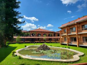 a large building with a pond in front of it at Hotel Lumbini Garden New Crystal in Rummindei