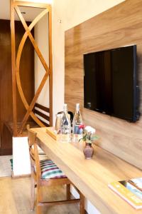 a wooden table with a tv on top of it at Hotel Lumbini Garden New Crystal in Rummindei