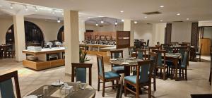 a restaurant with tables and chairs and a bar at Hotel Lumbini Garden New Crystal in Rummindei