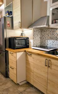 a kitchen with a microwave and a refrigerator at Resta Con Me in Genoa