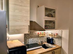 a kitchen with a sink and a counter top at Resta Con Me in Genoa +11 photos