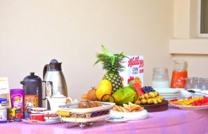 a table with a bunch of fruit on it at Moshono WiDa Lodge in Arusha
