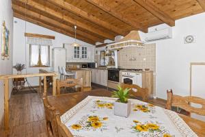 a kitchen and dining room with a table and chairs at Casa Mira by Rent Istria in Pazin