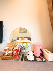 a room with a table with food and a bed at LALU Hotel in Phú Quốc