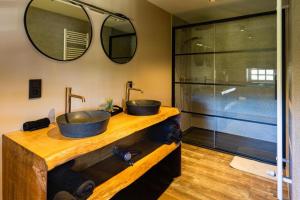 a bathroom with two sinks and a shower at lignely in Durbuy