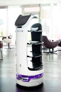a white and purple hair dryer sitting on a floor at Hotel Smartino in Schwäbisch Hall