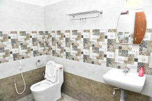 a bathroom with a toilet and a sink at La Maison Mira in Pondicherry +25 photos