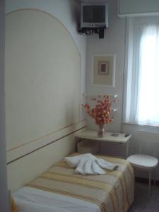 Uma cama ou camas num quarto em Hotel Arcade
