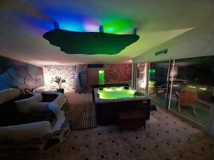 a living room with a pool table in the middle at Domaine de Planchoury in Saint-Michel-sur-Loire