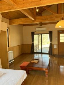 a room with a bed and a table in it at Katamaeyama Forest Park Cottage TypeC in Senboku
