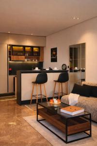 a living room with a couch and a table at Auralys Seaside Studio avec balcon in Casablanca