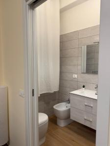 a bathroom with a white toilet and a sink at Piccola Isola in Parma