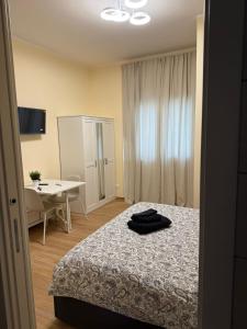 a bedroom with a bed and a desk and a table at Piccola Isola in Parma