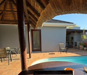 a patio with a pool and a table and chairs at Joys House in Cape Town