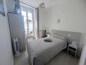 a small bedroom with a bed and a window at Hôtel de Clèves in Nevers +24 photos