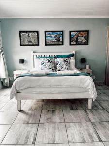 a bedroom with a large bed with blue walls at Hook Wine And Sinker in Langebaan
