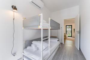 a room with two bunk beds and a hallway at Casa do Recanto - Loriga - Serra da Estrela in Loriga