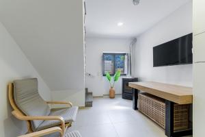 a living room with a tv and a table and chairs at Casa do Recanto - Loriga - Serra da Estrela in Loriga