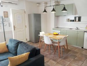 a kitchen and dining room with a table and a couch at Apartamento limonero ,VUT AL 13044 in Albox